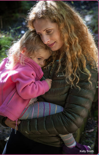 Mary Hohlman cuddling with daughter