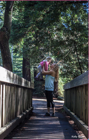 Mary Hohlman holding child up to trees